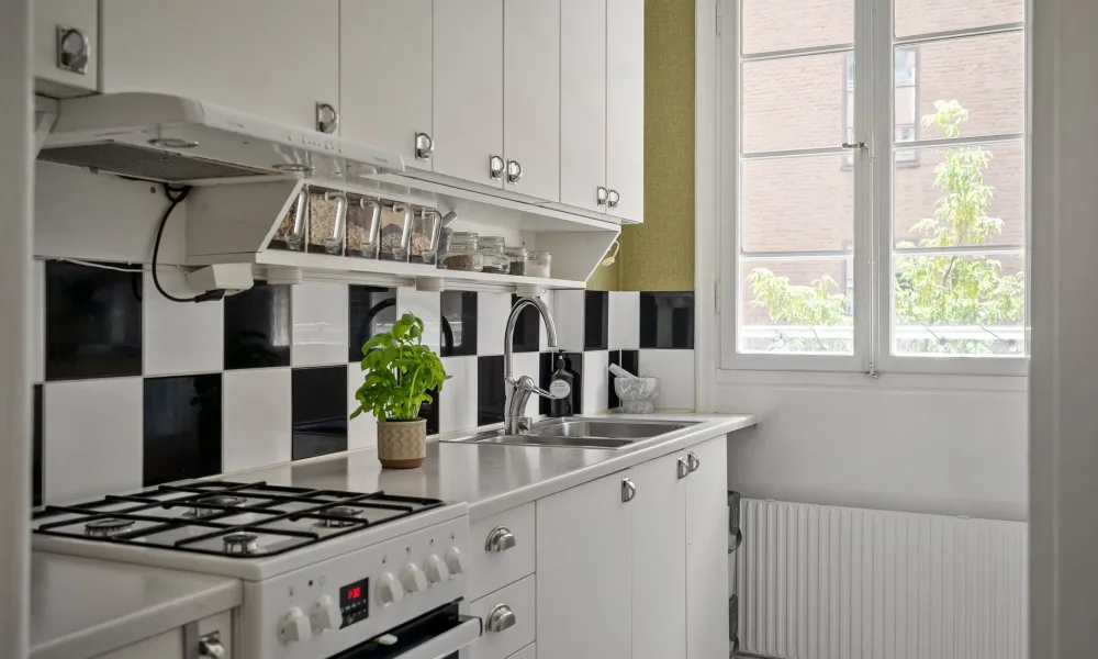small apartment kitchen counter with a compact ice maker and limited space