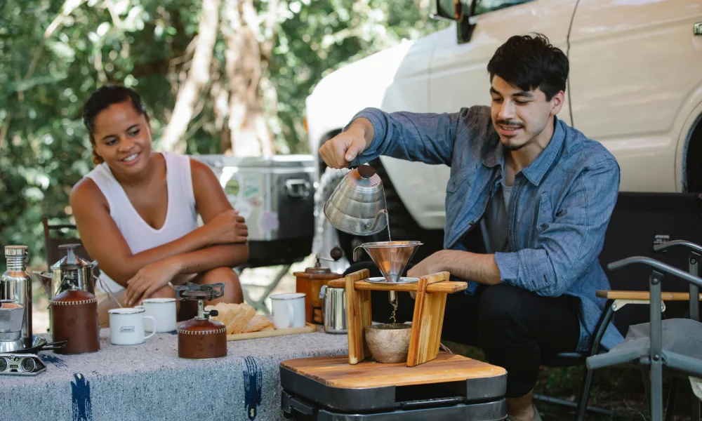 portable ice maker on tailgate table at outdoor campsite
