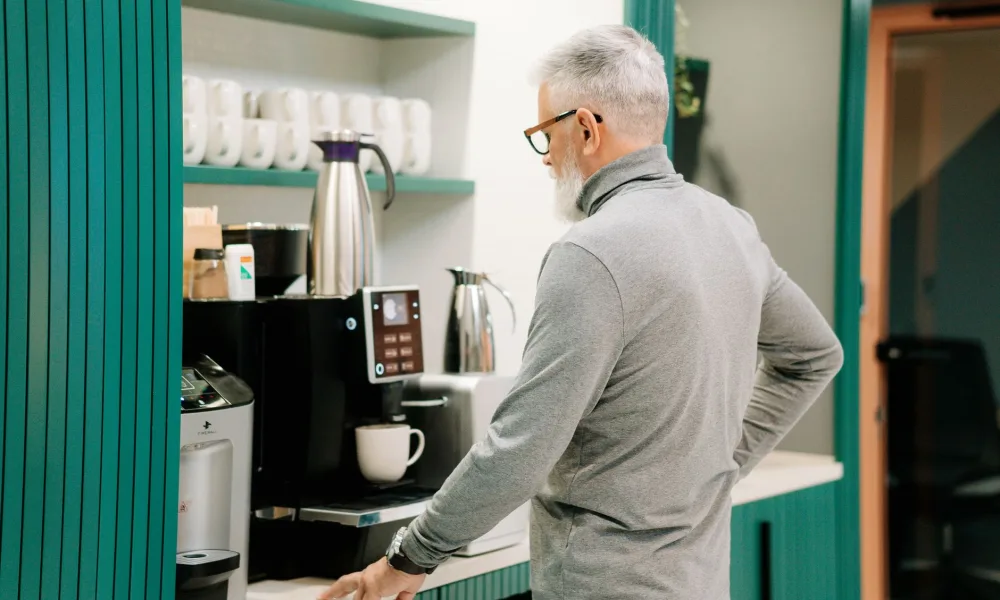 portable ice maker on office break room counter with coffee station