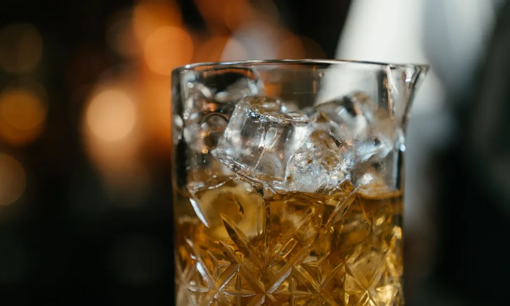melting ice cubes in glass on table timelapse
