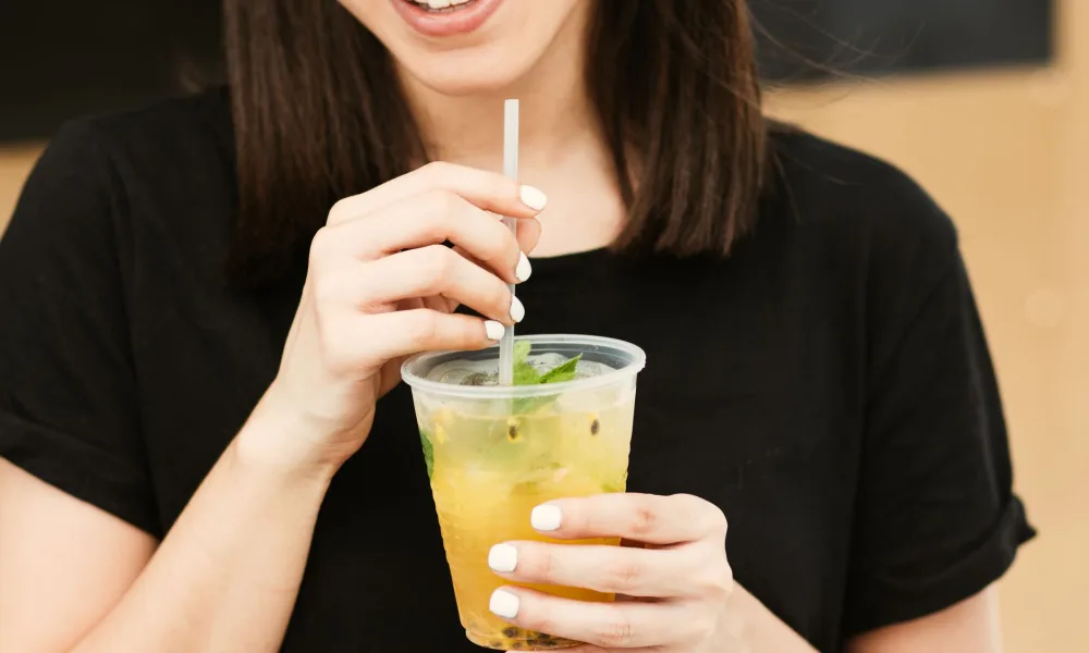 person chewing nugget ice from a cup