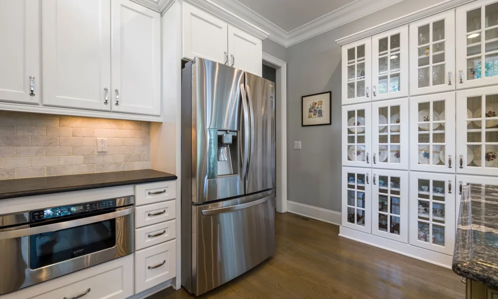 undercounter ice maker built into cabinetry next to a portable countertop unit
